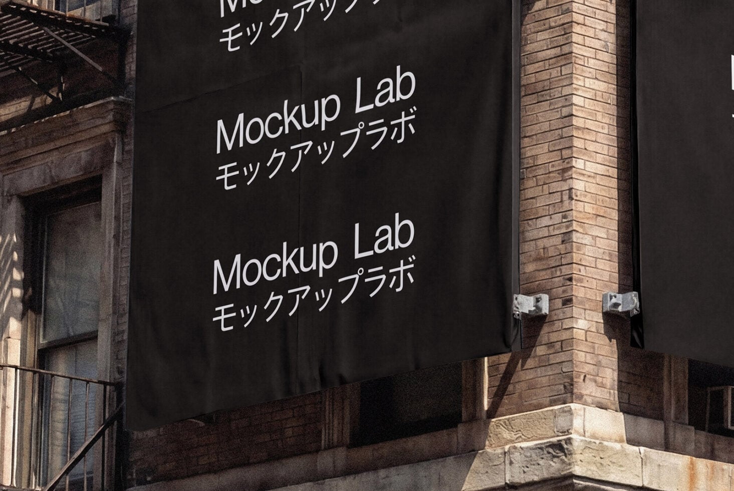 Large black banner on brick building with repeated white text