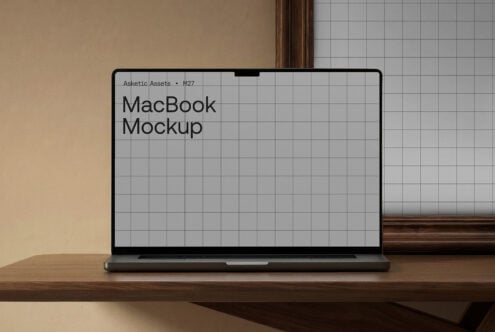 MacBook mockup on wood desk with light gray grid screen, neutral background
