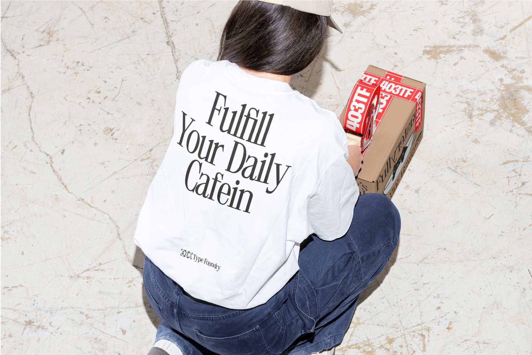 Person wearing white tee with Fulfill Your Daily Caffein print sitting overhead
