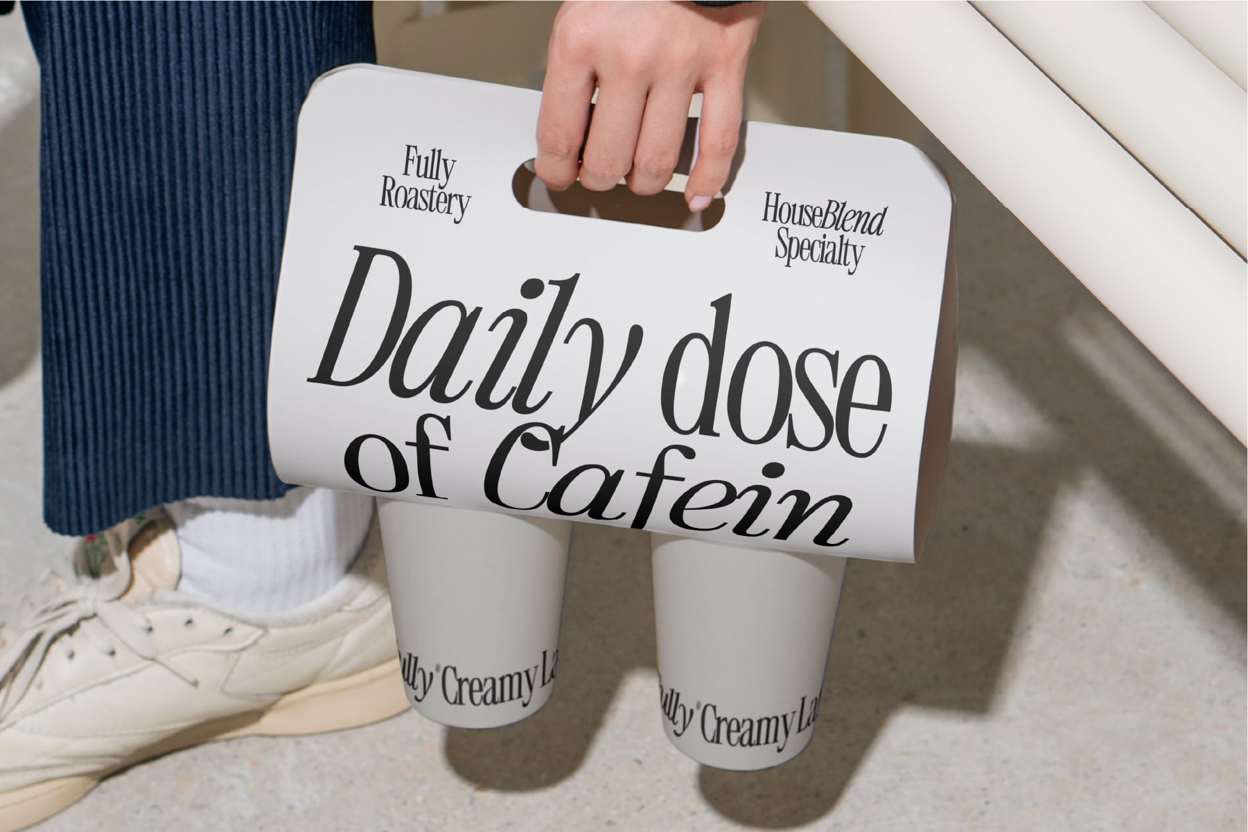Coffee shop branded takeout cup carrier with Daily Dose of Caffein text