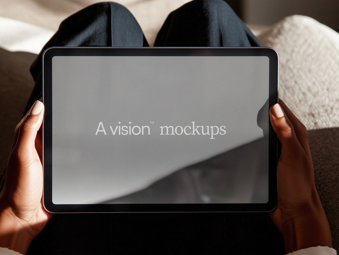 Tablet held in hands showing blank gray screen with text overlay