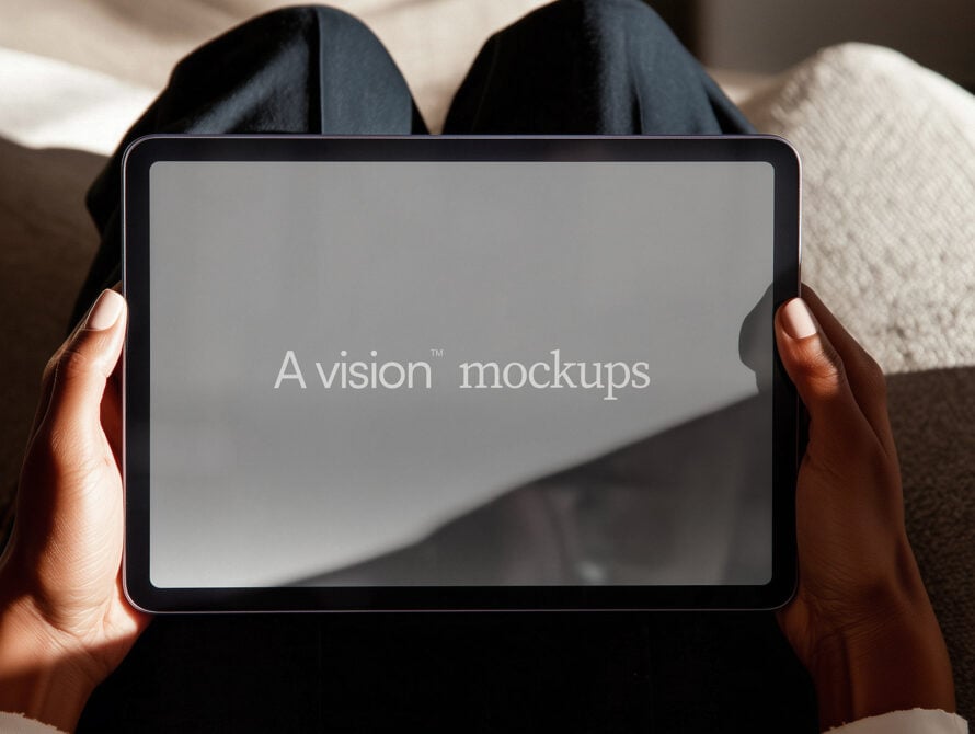 Tablet held in hands showing blank gray screen with text overlay