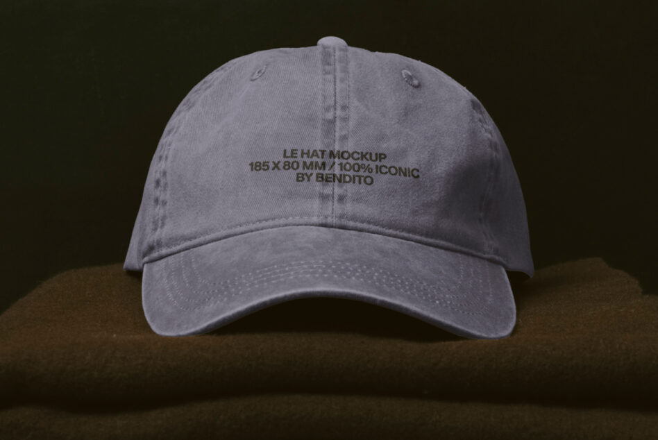 Washed grey cap with embroidered text on front against dark background