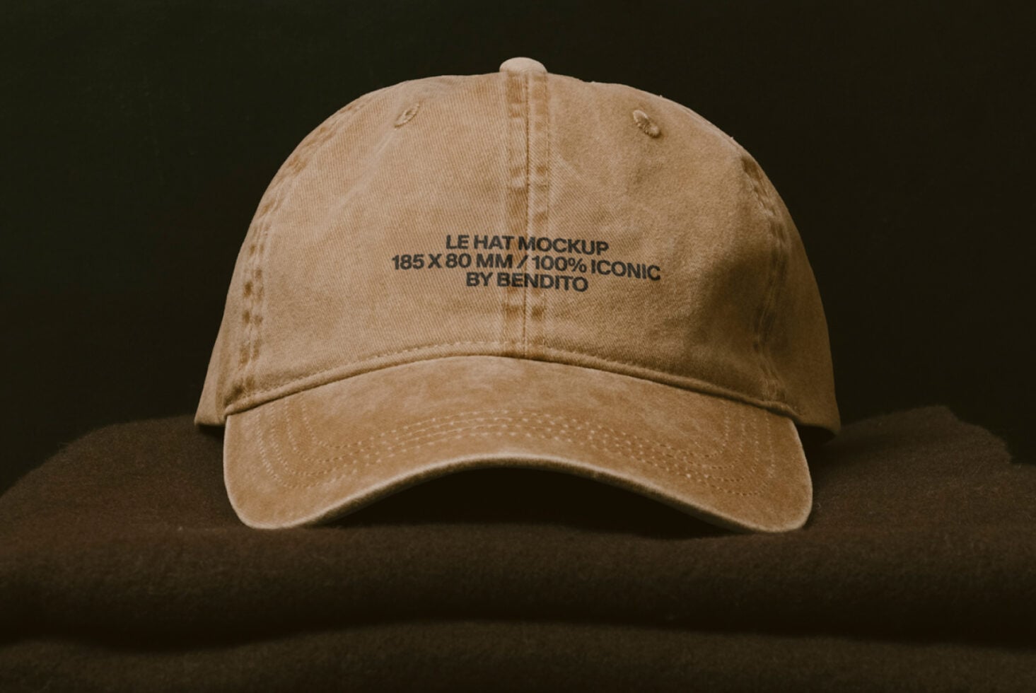 Vintage tan baseball cap with embroidered text displayed on neutral backdrop