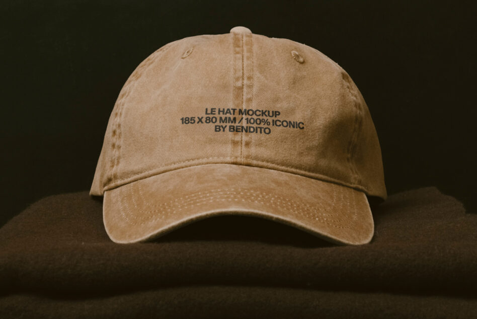 Vintage tan baseball cap with embroidered text displayed on neutral backdrop