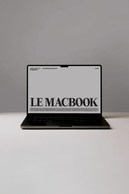 Black MacBook mockup on gray background with LE MACBOOK displayed on screen