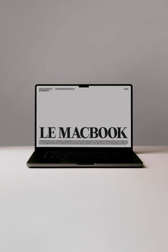 Black MacBook mockup on gray background with LE MACBOOK displayed on screen