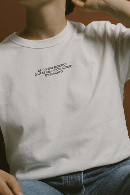 Cream colored t-shirt on person showing Let Shirt Mockup text printed on chest