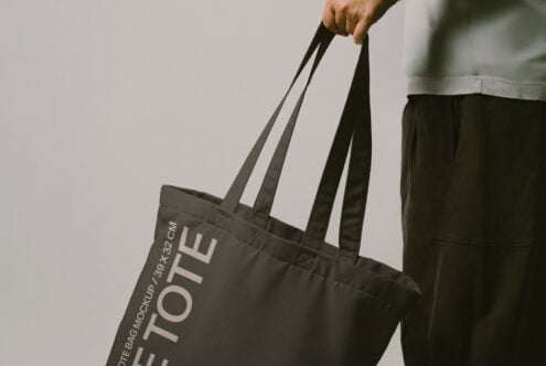Close up of black canvas tote bag with Let Tote Bag Mockup text visible on front panel