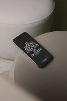 Black iPhone resting on cream ceramic bowl with minimalist styling