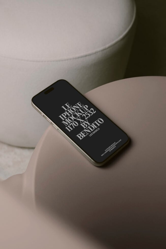 Black iPhone resting on cream ceramic bowl with minimalist styling