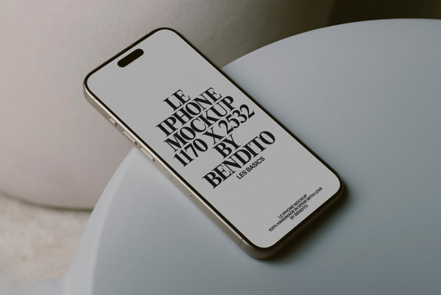 White iPhone 14 Pro mockup positioned on soft sculptural pottery form