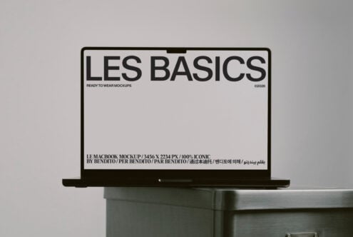 MacBook mockup with light screen showing Les Basics branding on desk