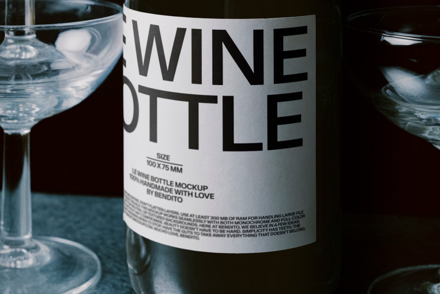 Wine bottle with white label on neutral background, sitting next to filled glasses