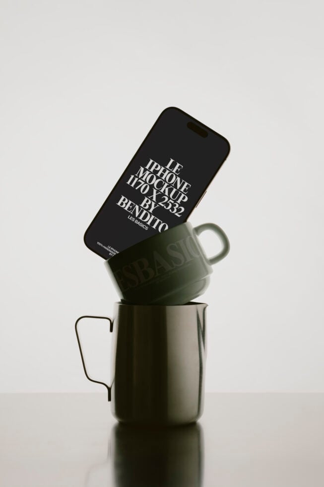 Black iPhone propped on ceramic mug showing Bendito mockup design from above