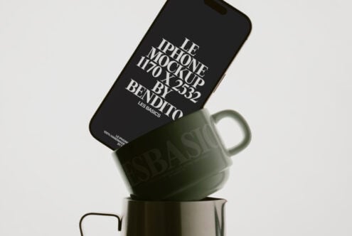 Black iPhone balanced on matte green cup displaying typography mockup layout