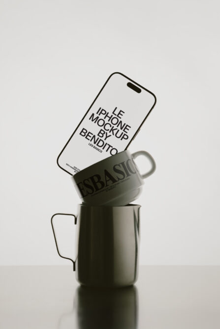 White iPhone leaning against sage green mug with Bendito branding visible
