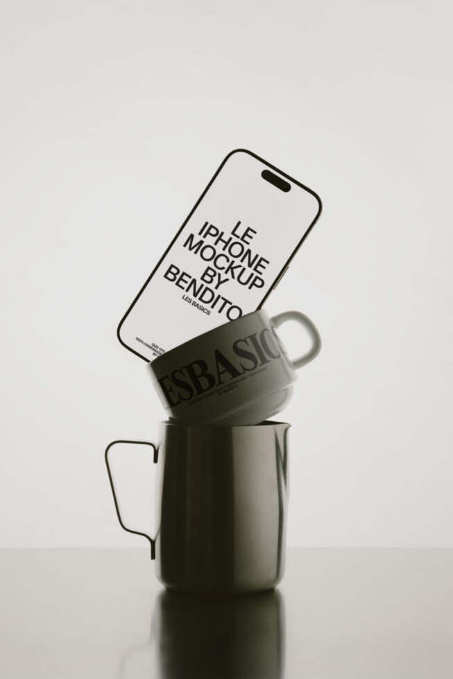 White iPhone leaning against sage green mug with Bendito branding visible