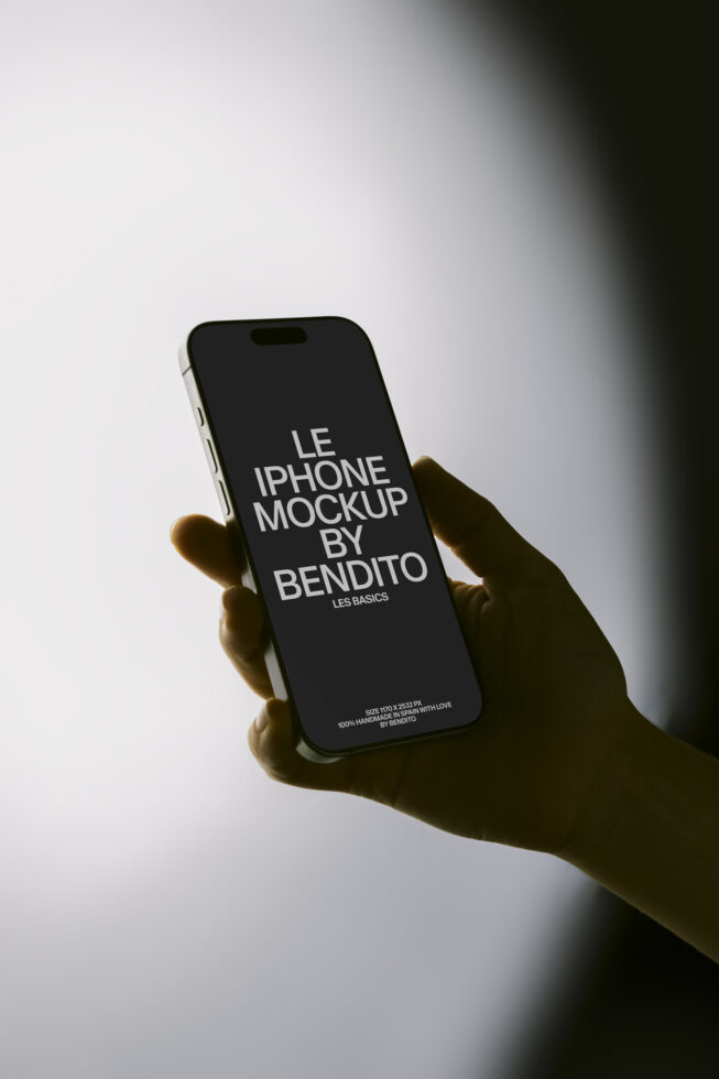 Black iPhone mockup in hand with dramatic side lighting on white