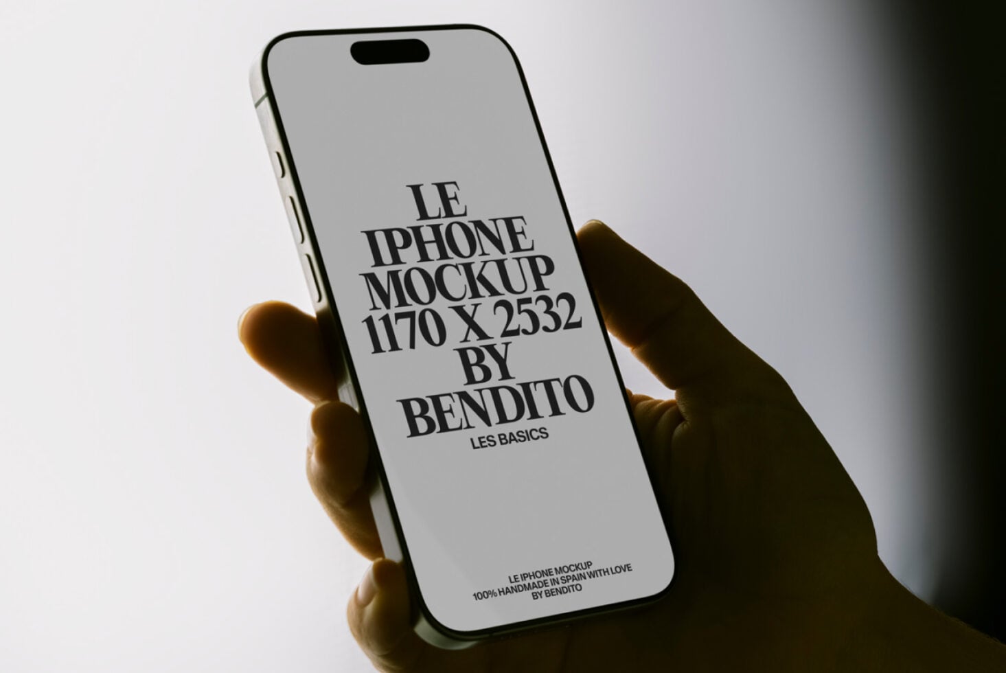 Light gray iPhone held in hand displaying Bendito mockup with black text layout