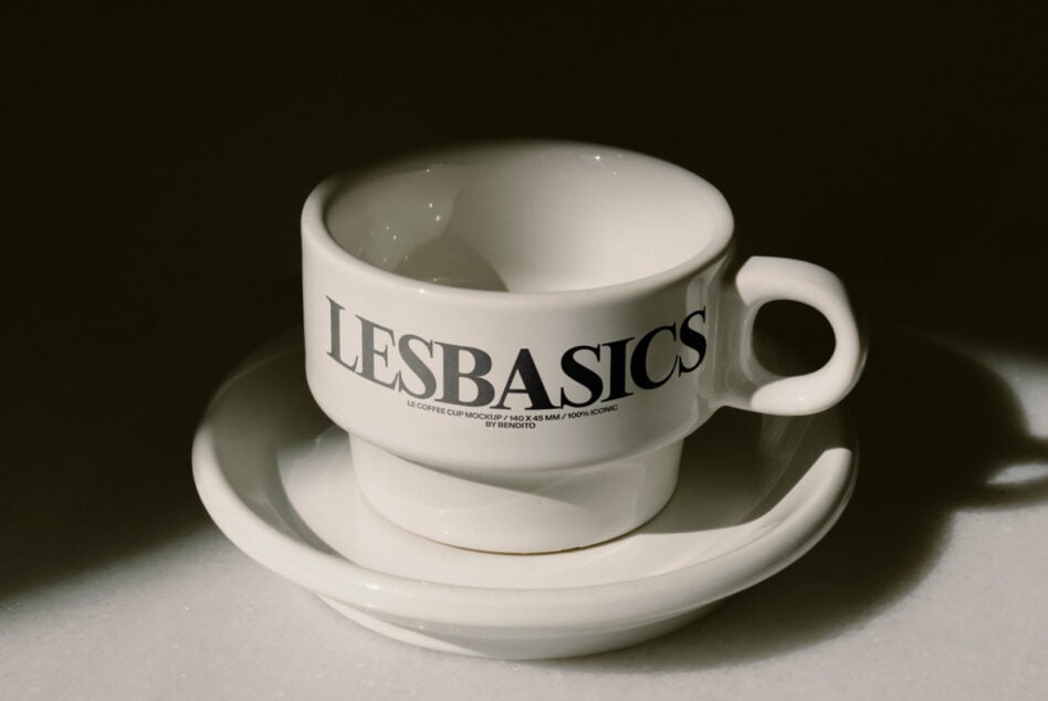 White stoneware mug on matching saucer with LE BASICS branding visible
