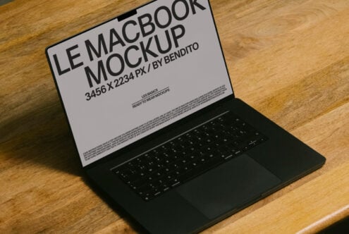 Light screen MacBook on oak desk showing mockup template from side view
