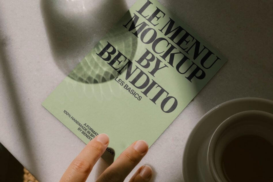 Green leaflet mockup angled shot with coffee cups below