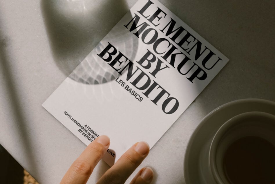 Cream leaflet mockup in hand, styled with dishes overhead