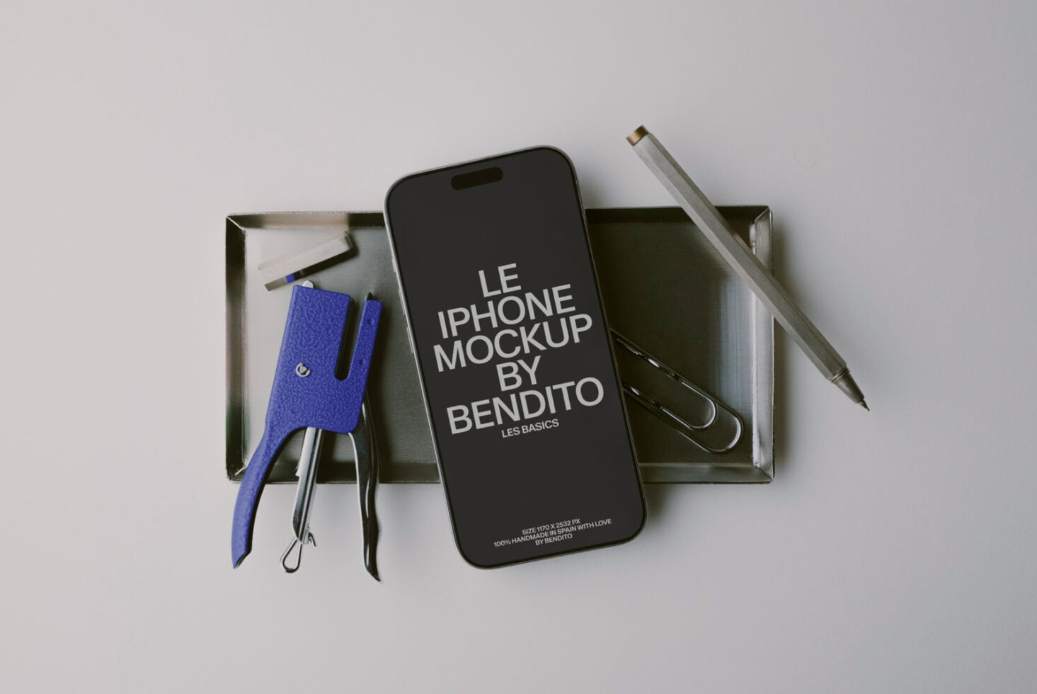 iPhone mockup flat lay with blue leather phone sleeve, pens, scissors in metal tray