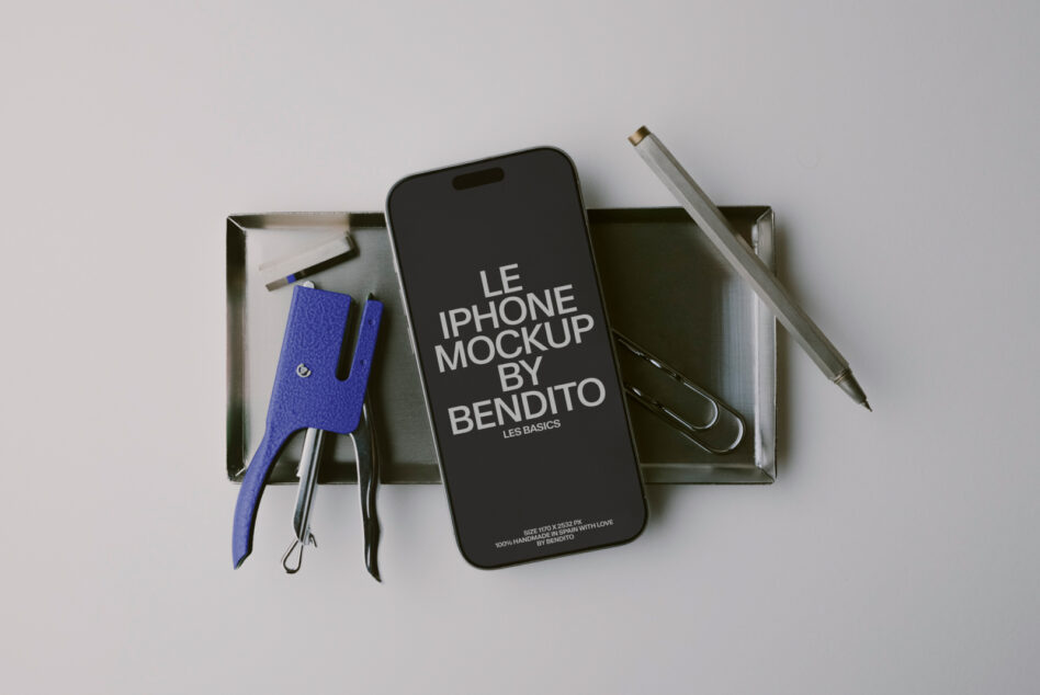 iPhone mockup flat lay with blue leather phone sleeve, pens, scissors in metal tray