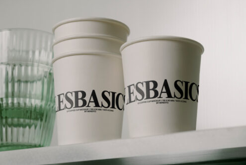 Two cream colored coffee cups labeled LESBASIC side by side
