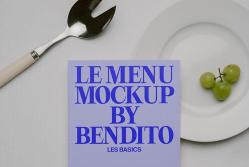 Blue text menu mockup on lavender card with fork, plate, grapes on white surface