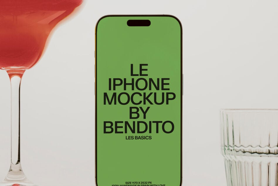 Lime green iPhone mockup between red cocktail glass, water glasses on minimal white surface