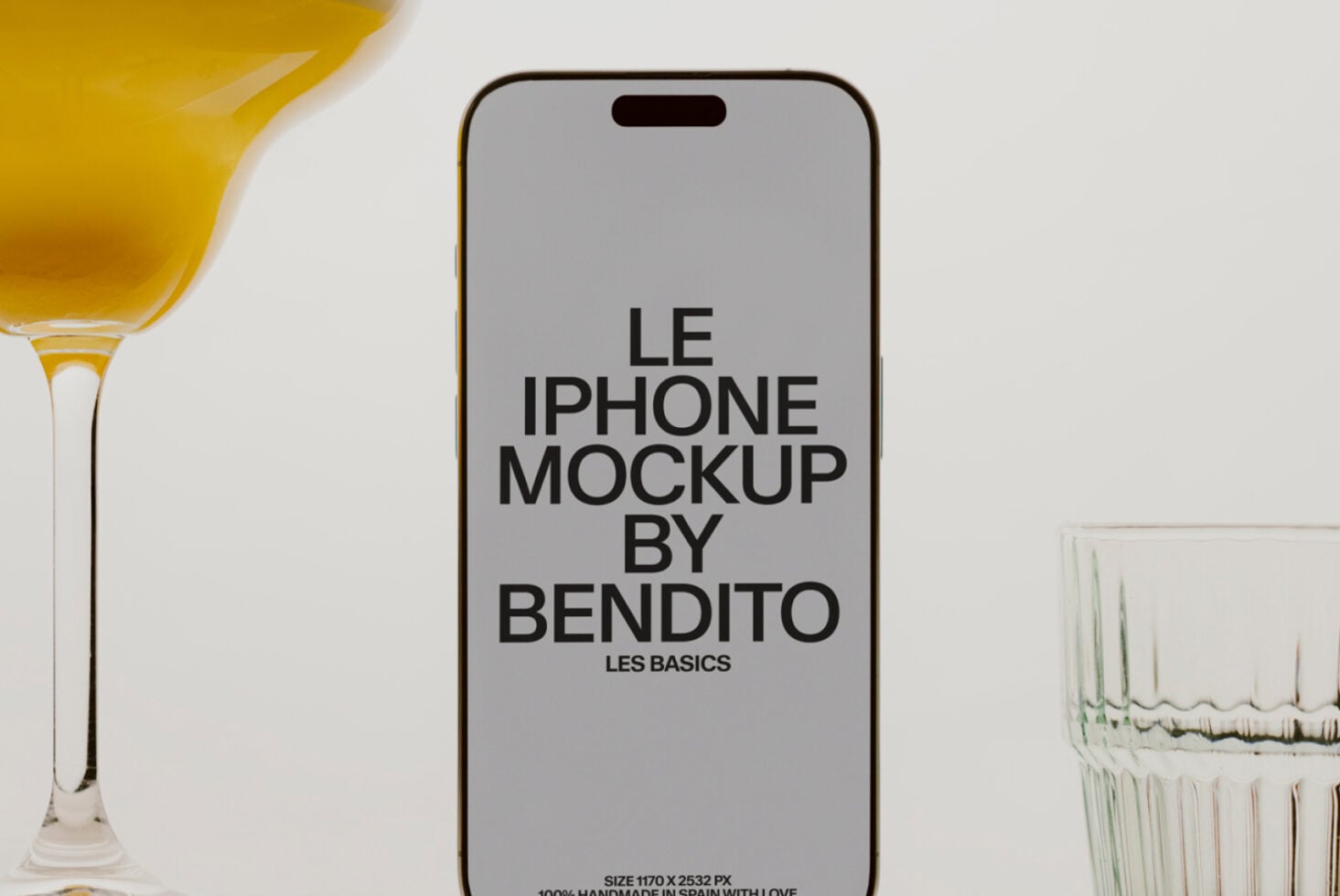 Gray iPhone mockup surrounded by golden cocktail, water glasses on styled tabletop