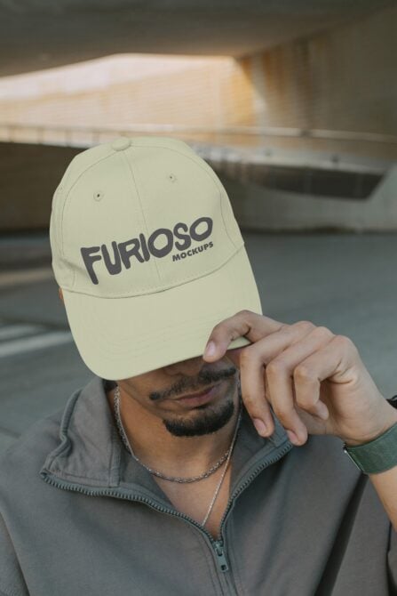Pale yellow cap featuring Furioso Mockups logo held by person