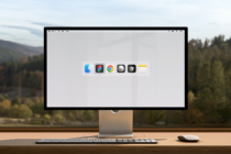 Computer screen mockup displaying app icons for design software with scenic nature view in background suitable for designers' digital assets marketplace