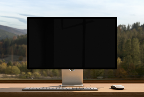Desktop monitor mockup on wooden desk with natural background for design presentations ideal for designers in need of realistic workspace templates