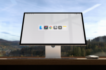 Wide monitor mockup on a desk with scenic view background icons on screen useful for graphic design presentations digital workspace templates