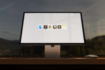 Computer screen displaying app icons on a desktop against a scenic background for mockup design. Keywords: digital, monitor, interface, workspace.