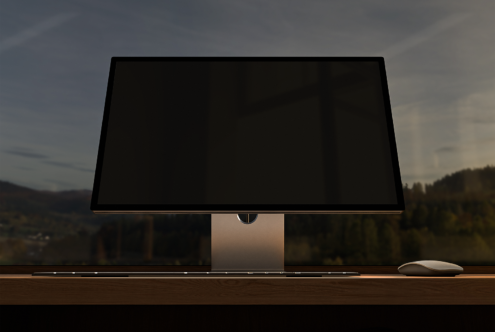 Minimalist desktop computer mockup with monitor keyboard and mouse on wooden desk in front of window ideal for design presentations or templates.
