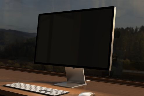 Minimalist computer monitor mockup on a wooden desk with keyboard and mouse. Ideal for digital display designs. Keywords: mockup, monitor, desk, design