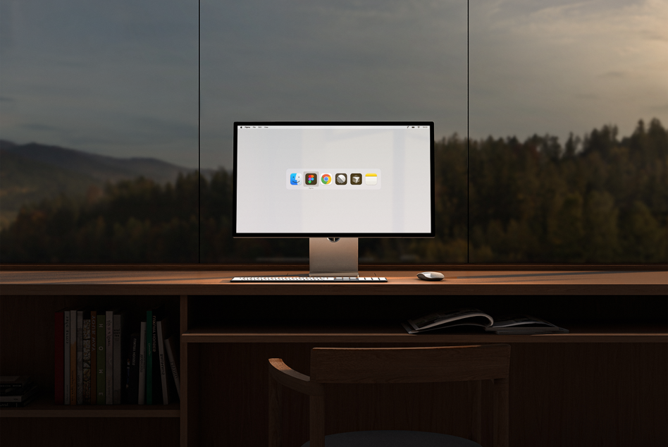 Modern desktop computer setup on wooden desk with keyboard and mouse, large window overlooking forest. Ideal for office mockup or workspace design