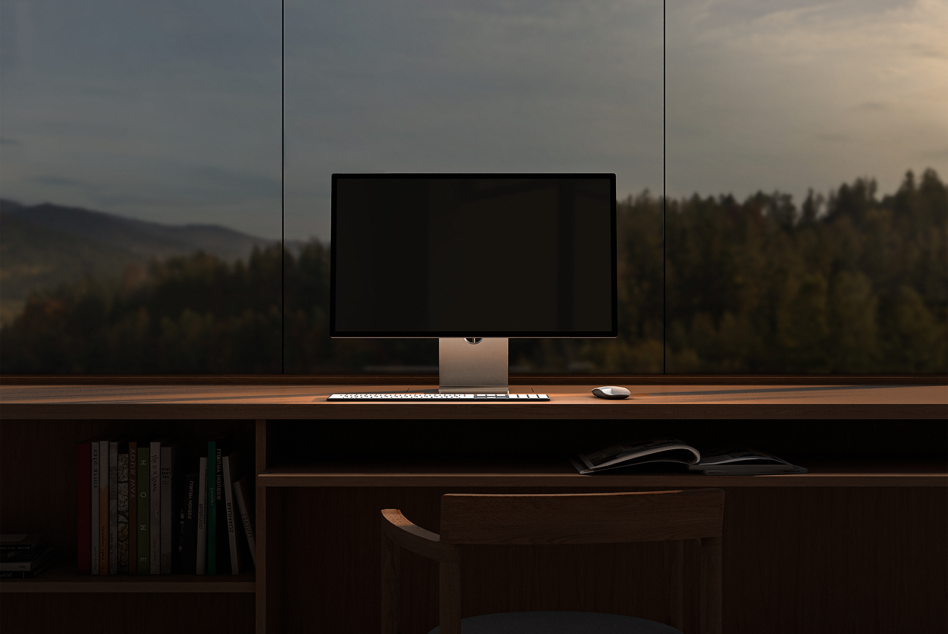 Minimalist workspace mockup featuring a sleek desktop monitor keyboard and mouse on a wooden desk with a scenic forest view perfect for designers