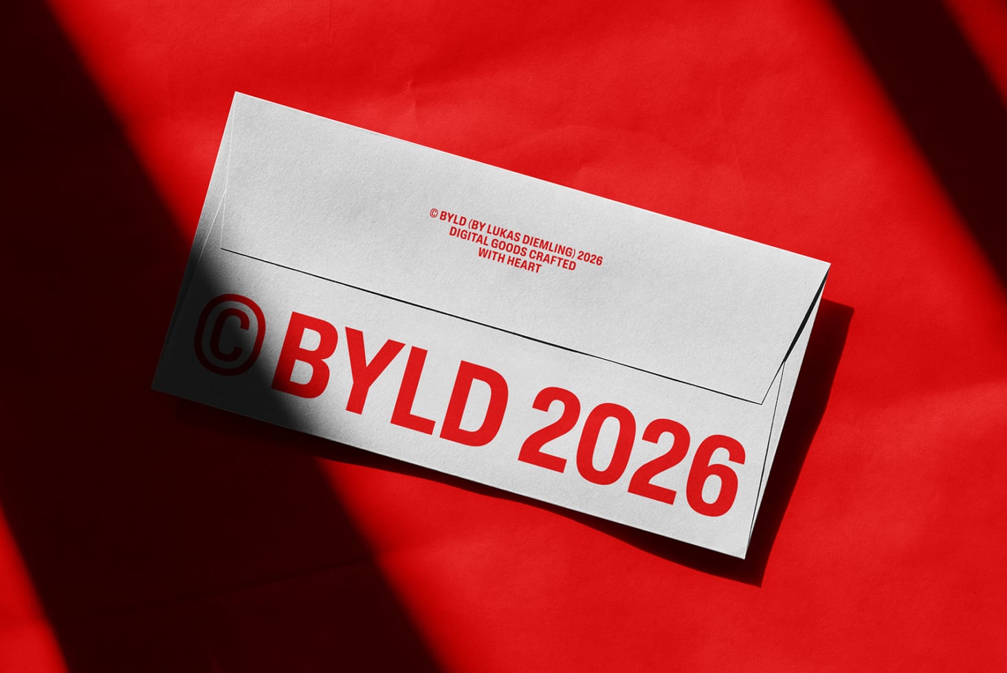 White business envelope mockup with red BYLD 2026 branding on red background
