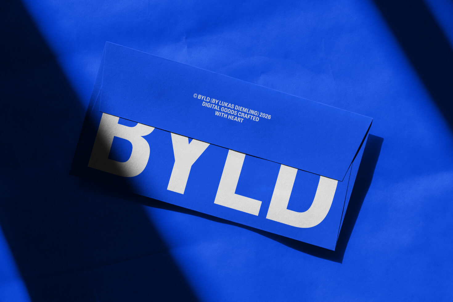Blue business card mockup with white typography under soft shadow lighting