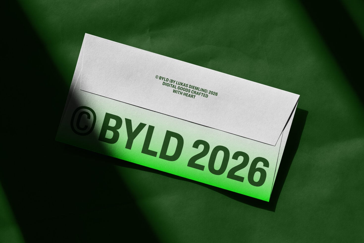 White envelope mockup with green accent edge under soft side lighting