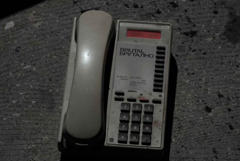 Old phone handset beside brutalist design mockup with red serbia label