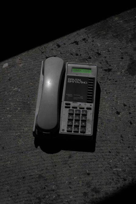 Vintage rotary phone with green label displaying Brutal Brutalno branding mockup
