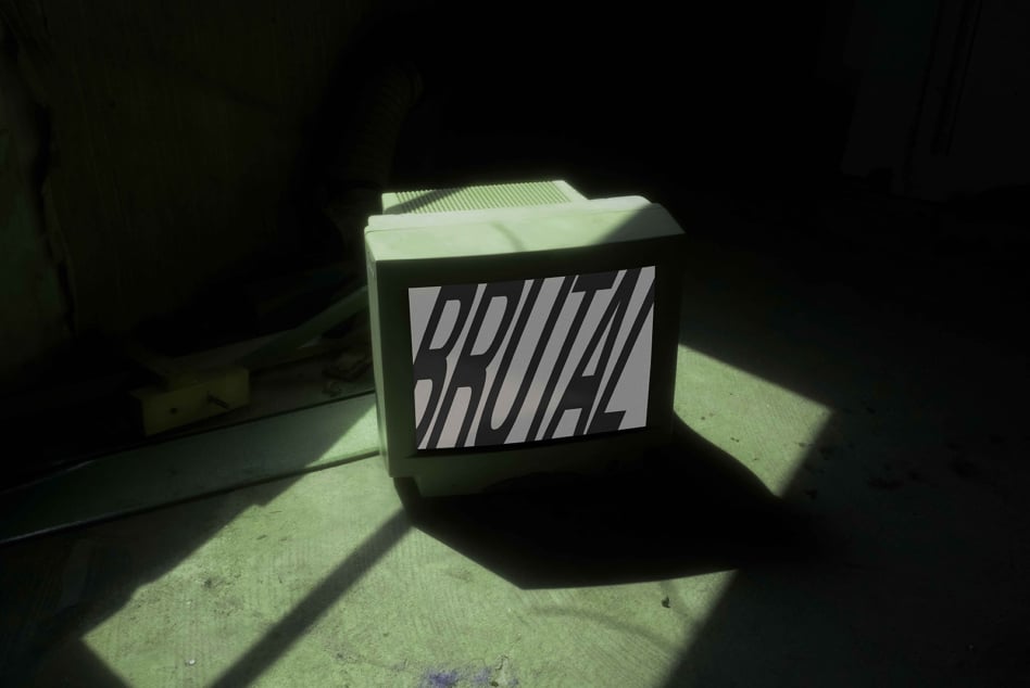 Brutal box mockup casting green shadow on concrete floor