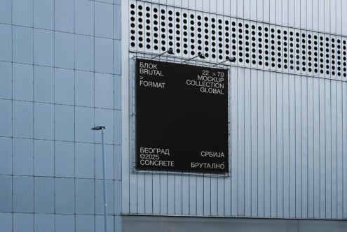 Black billboard mockup on perforated metal building with brutal branding type